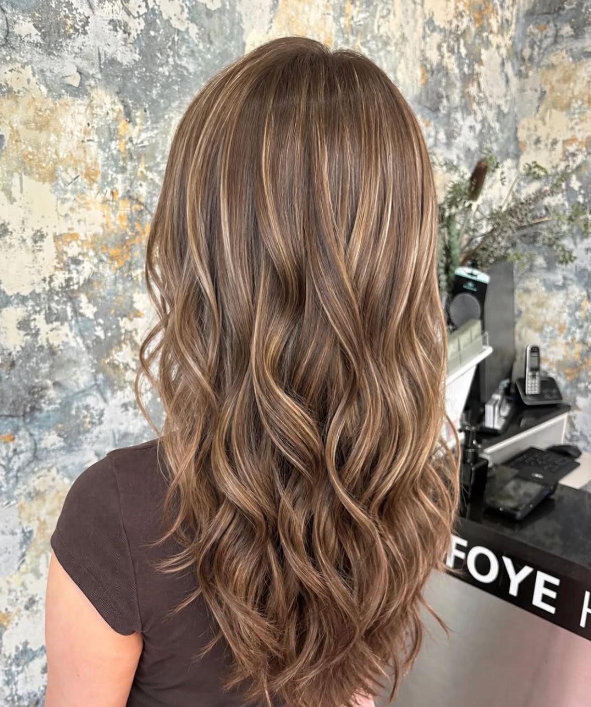 Glossy brunette hair styled in soft waves